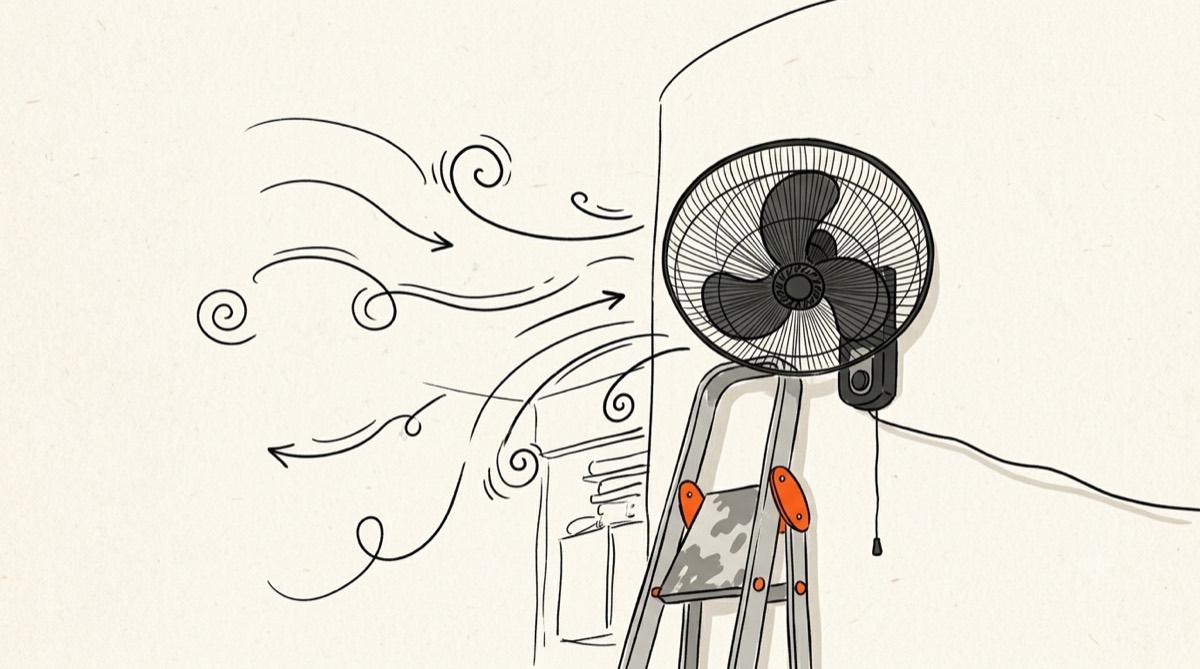 Line drawing of a wall fan above a stepladder, with air flowing into the room